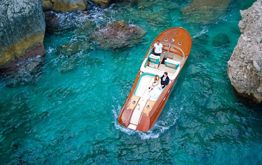 Riva motorboat in teh blue waters of Capri